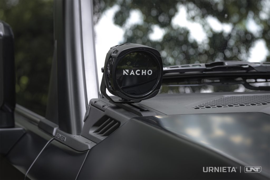 URNIETA LC250 A-Pillar Lighting Brackets on a Toyota Land Cruiser 250, round auxiliary light mounted on the A-pillar bracket, forest background
