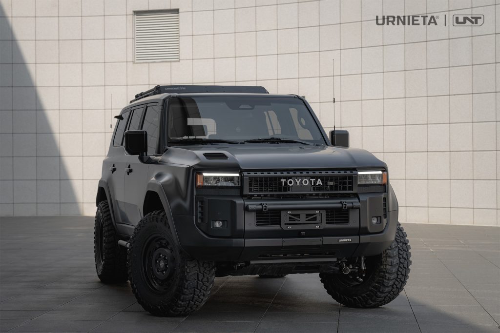 URNIETA LC250 Front Fascia Kit on a Toyota Land Cruiser 250, wide front three-quarter view against a white tiled wall