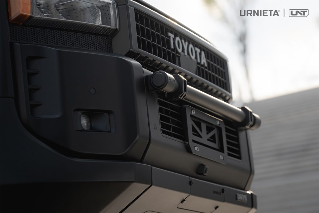 URNIETA LC250 Front Fascia Kit on a Toyota Land Cruiser 250, detail of the headlight, grille mesh, mini bull bar end, hidden winch port plate and side vent