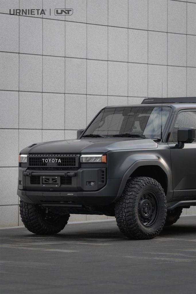URNIETA LC250 Front Fascia Kit on a Toyota Land Cruiser 250, front three-quarter view parked on an urban plaza beside a white tiled wall