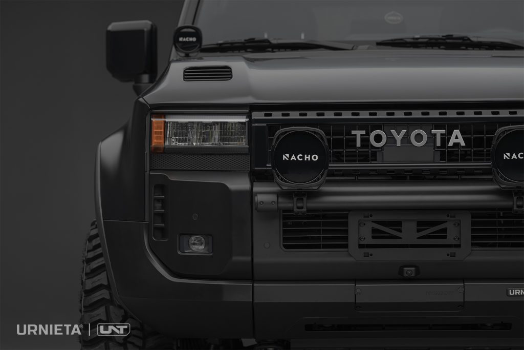 URNIETA LC250 Front Fascia Kit on a Toyota Land Cruiser 250, studio close-up of the front corner with round auxiliary lights