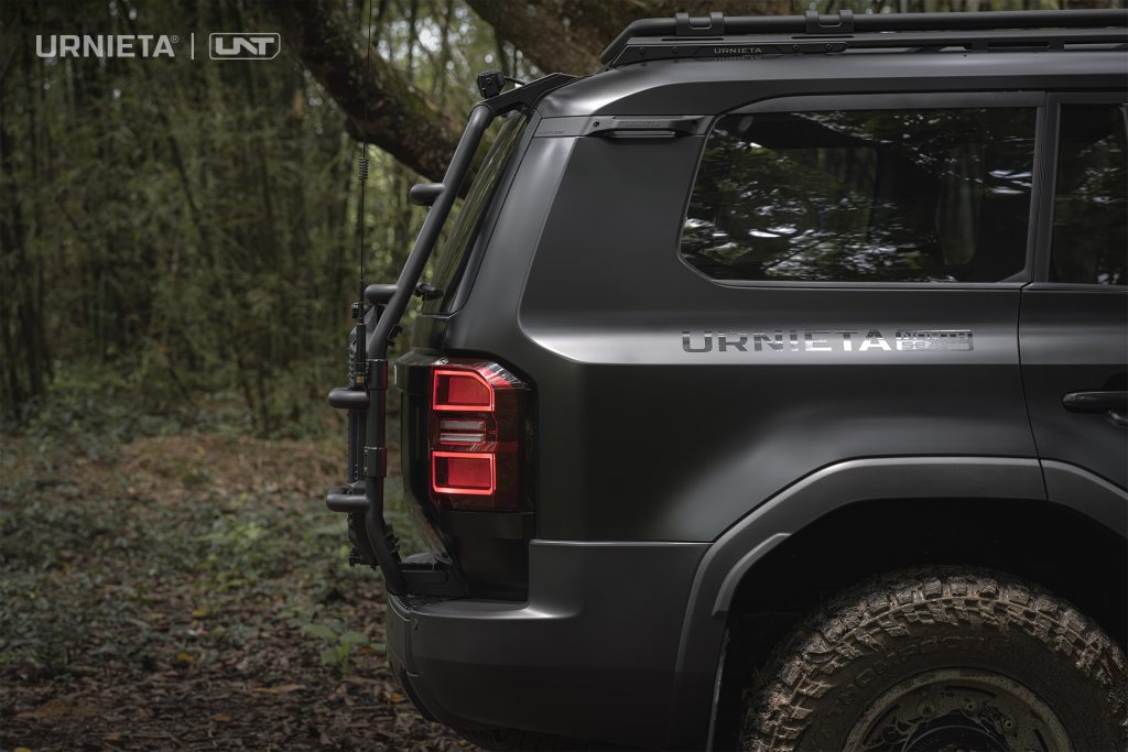 URNIETA Rear Ladder Kit for Land Cruiser 250, side view of the ladder mounted on the tailgate, forest background