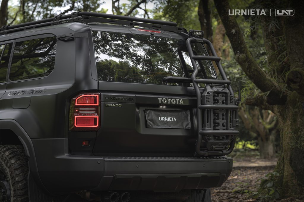 URNIETA Rear Ladder Kit for Land Cruiser 250, rear view of the ladder with recovery board in a forest