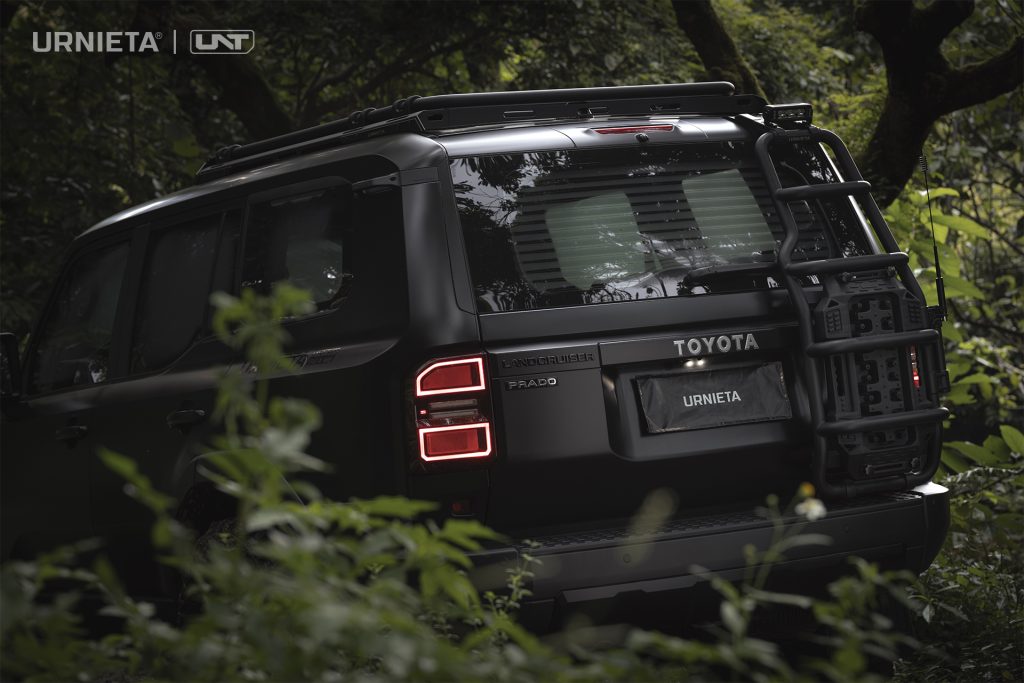 URNIETA Rear Ladder Kit for Land Cruiser 250, rear three-quarter view seen through foliage