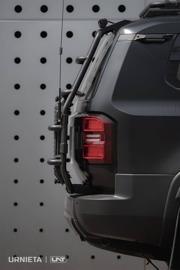 URNIETA Rear Ladder Kit for Land Cruiser 250, side view of the ladder with antenna against a perforated wall